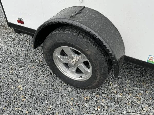 2024 Cargo Mate 5.5x10' Enclosed Toy Hauler Trailer 2990# GVW * TOY HAULER * FOLD OUT BED * WHITE BLACKOUT * SLANT V-NOSE * ALUMINUM WHEELS * .030 SCREWLESS EXTERIOR * REAR SPOILER * PLYWOOD FLOORS/WALLS * TABLE * MAX AIR COVER * EXTRA HEIGHT - Image 8