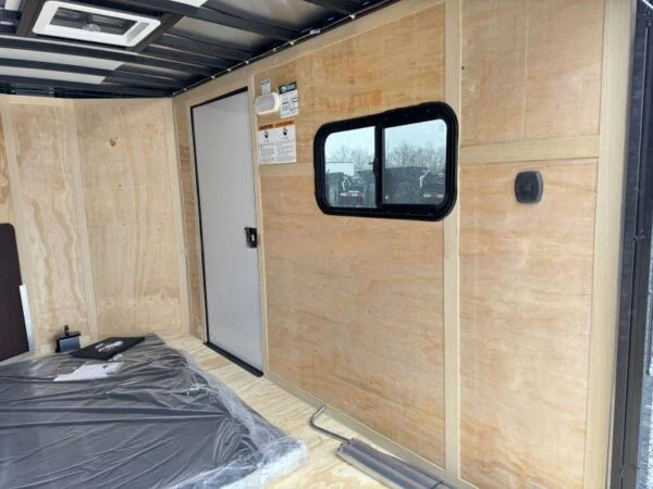 2024 Cargo Mate 5.5x10' Enclosed Toy Hauler Trailer 2990# GVW * TOY HAULER * FOLD OUT BED * WHITE BLACKOUT * SLANT V-NOSE * ALUMINUM WHEELS * .030 SCREWLESS EXTERIOR * REAR SPOILER * PLYWOOD FLOORS/WALLS * TABLE * MAX AIR COVER * EXTRA HEIGHT - Image 4