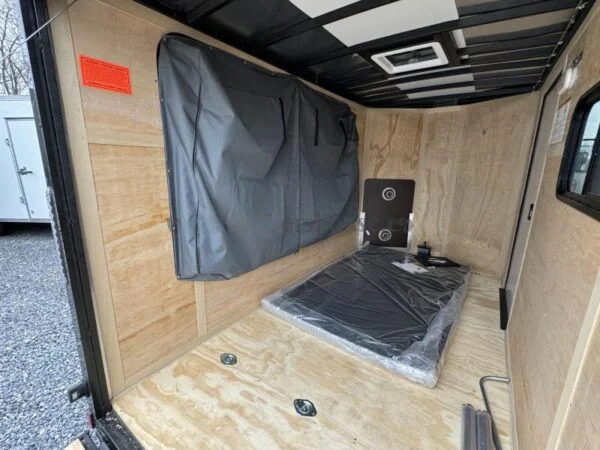 2024 Cargo Mate 5.5x10' Enclosed Toy Hauler Trailer 2990# GVW * TOY HAULER * FOLD OUT BED * WHITE BLACKOUT * SLANT V-NOSE * ALUMINUM WHEELS * .030 SCREWLESS EXTERIOR * REAR SPOILER * PLYWOOD FLOORS/WALLS * TABLE * MAX AIR COVER * EXTRA HEIGHT - Image 3