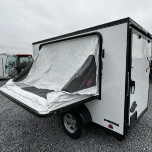 2024 Cargo Mate 5.5x10' Enclosed Toy Hauler Trailer 2990# GVW * TOY HAULER * FOLD OUT BED * WHITE BLACKOUT * SLANT V-NOSE * ALUMINUM WHEELS * .030 SCREWLESS EXTERIOR * REAR SPOILER * PLYWOOD FLOORS/WALLS * TABLE * MAX AIR COVER * EXTRA HEIGHT